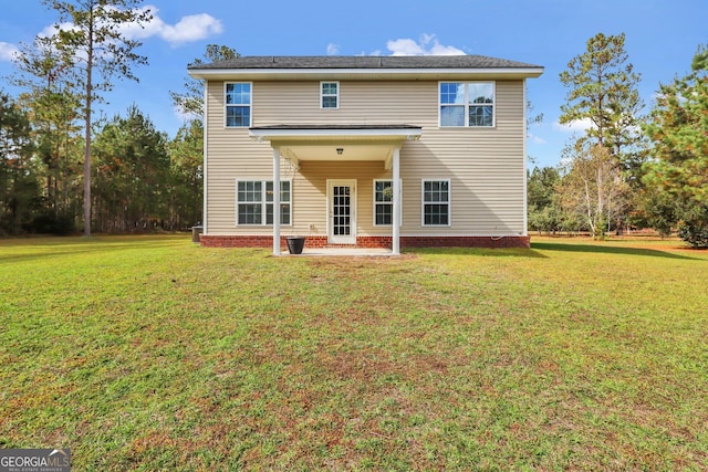 rear view of property featuring a patio and a yard