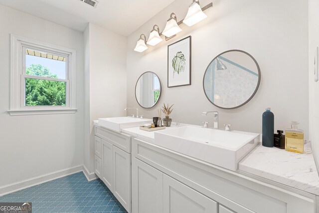 bathroom featuring tile patterned flooring and vanity