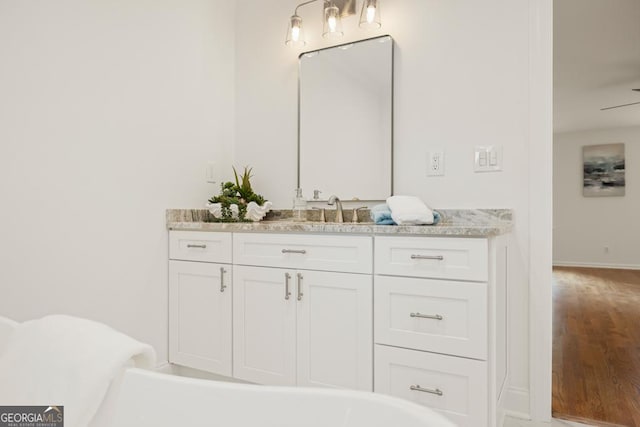 bathroom with ceiling fan and vanity