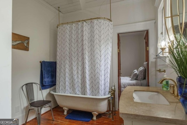 bathroom featuring wooden ceiling, a tub, hardwood / wood-style floors, vanity, and crown molding