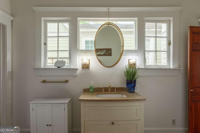 bathroom with vanity, crown molding, and plenty of natural light