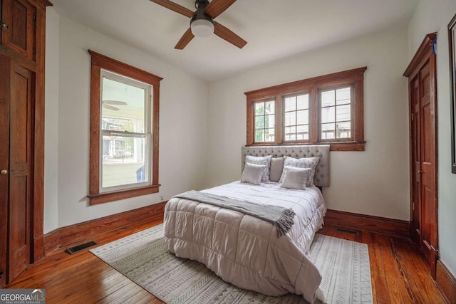 bedroom with dark wood-type flooring and ceiling fan