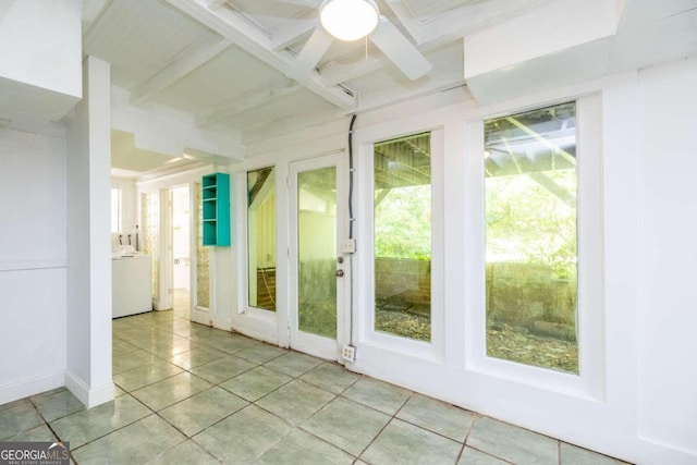 unfurnished sunroom featuring beamed ceiling, ceiling fan, and washer / dryer