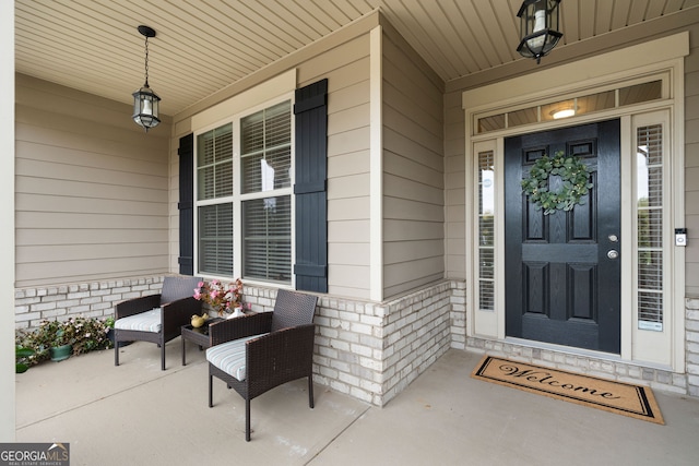 view of exterior entry with covered porch