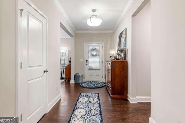 entryway with ornamental molding and dark hardwood / wood-style floors