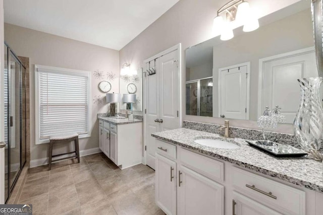 bathroom with vanity and a shower with shower door