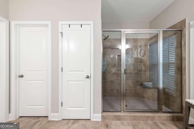 bathroom with tile patterned floors and a shower with shower door