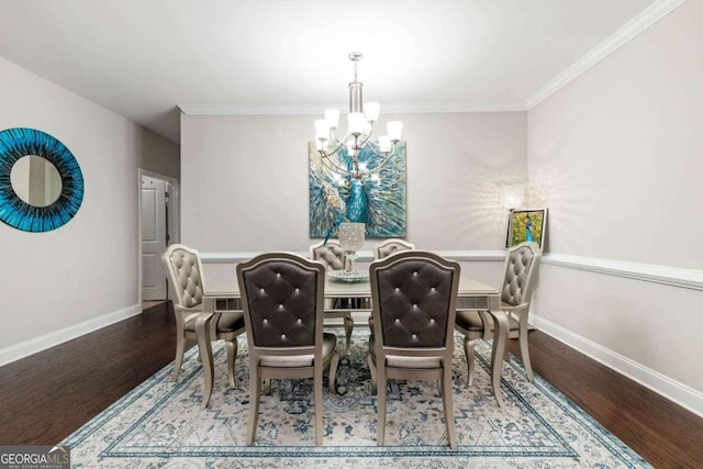 dining room with hardwood / wood-style floors, crown molding, and an inviting chandelier