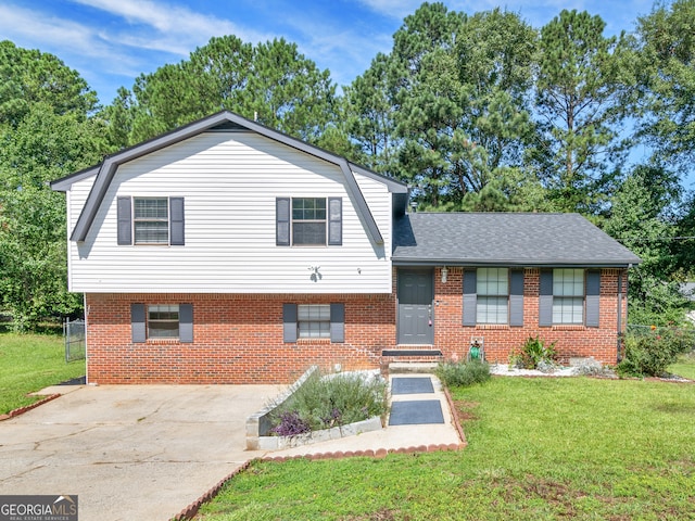 split level home featuring a front lawn