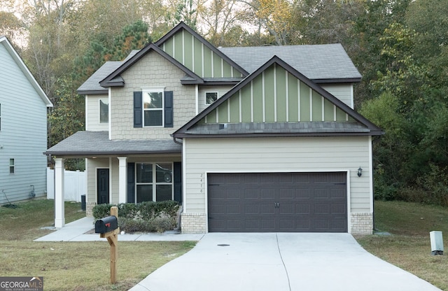 craftsman inspired home with a garage and a front yard