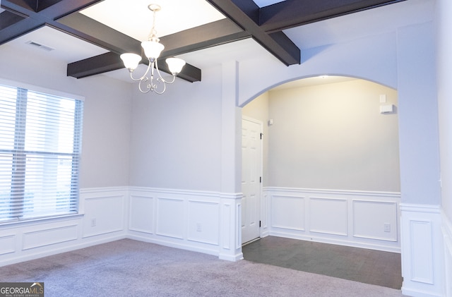 spare room with beamed ceiling and light carpet