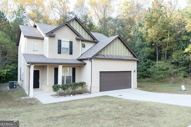 view of front of house with covered porch, central AC unit, a front lawn, and a garage