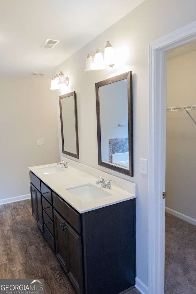 bathroom featuring hardwood / wood-style flooring and vanity