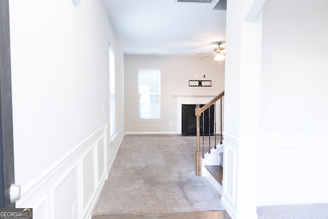 staircase featuring carpet flooring and ceiling fan