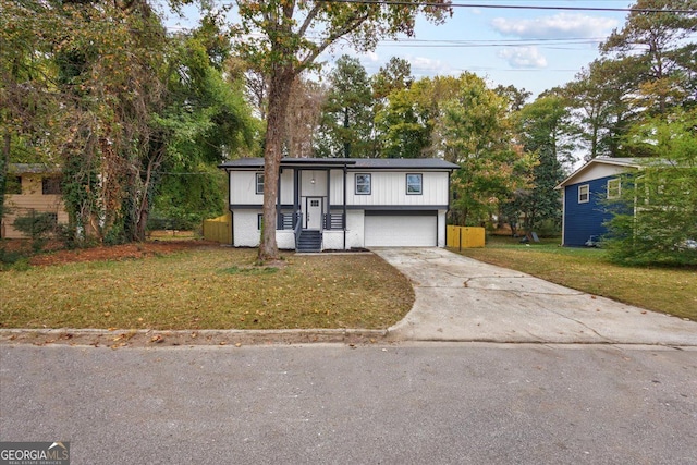 split foyer home with a garage and a front lawn