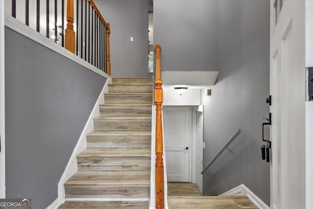 stairs featuring hardwood / wood-style floors