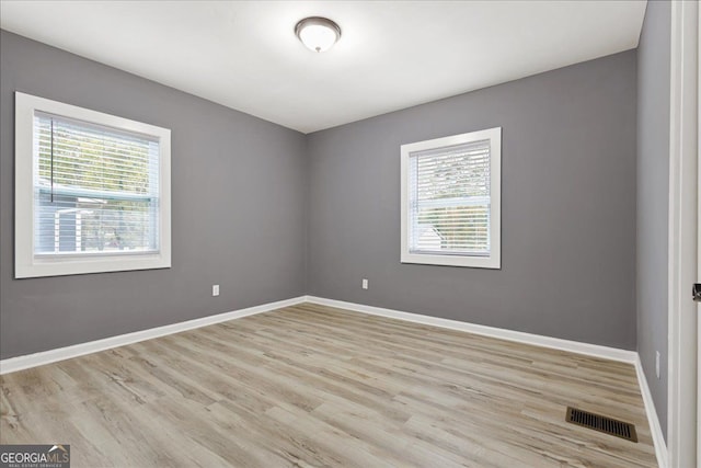 spare room with light hardwood / wood-style flooring