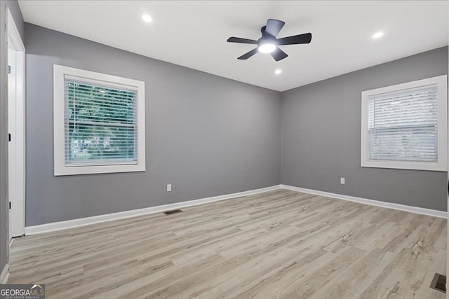 unfurnished room with light hardwood / wood-style flooring, ceiling fan, and plenty of natural light