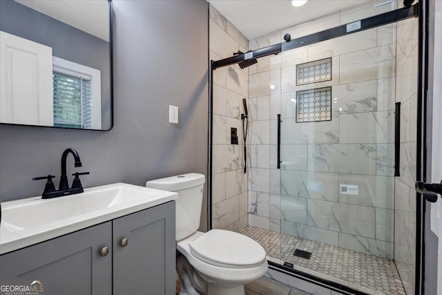 bathroom with baseboard heating, vanity, toilet, and an enclosed shower