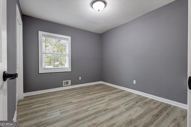 spare room featuring light hardwood / wood-style floors