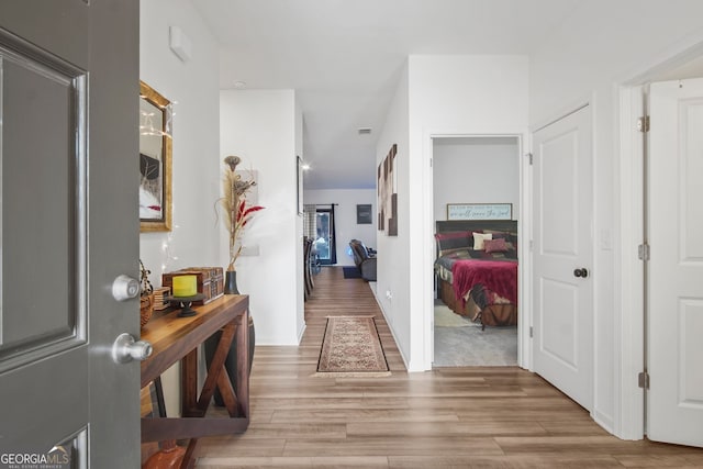 corridor featuring wood-type flooring