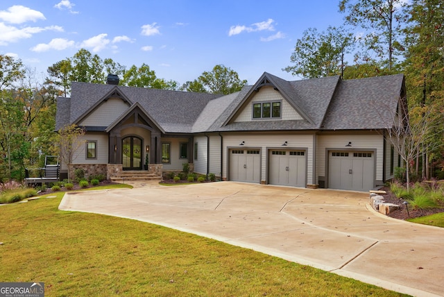 view of front of property featuring a garage and a front yard