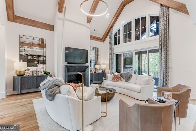 living room with high vaulted ceiling, light wood-type flooring, french doors, and a fireplace