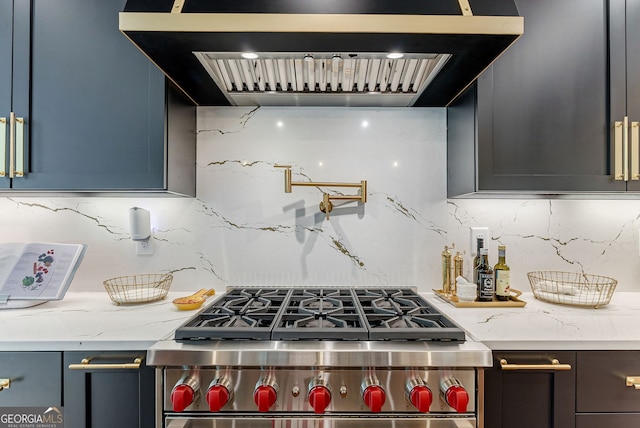 kitchen featuring tasteful backsplash, stainless steel range, wall chimney exhaust hood, and light stone countertops