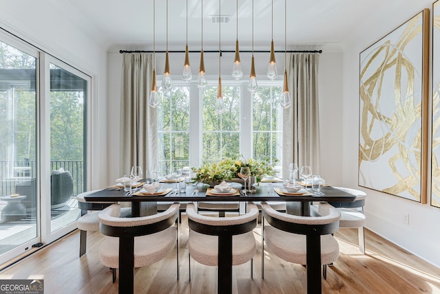 dining space with plenty of natural light and light hardwood / wood-style flooring