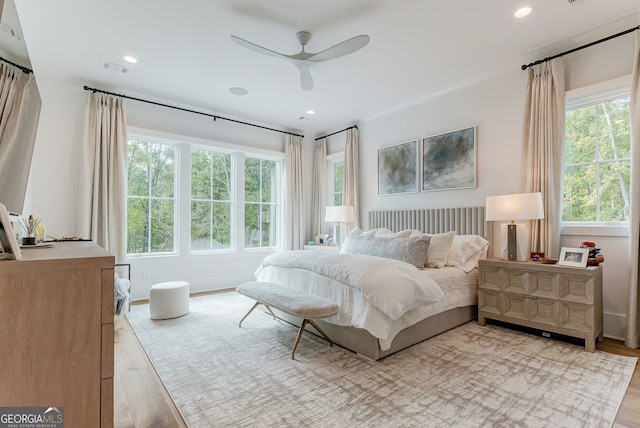 bedroom with light wood-type flooring and ceiling fan