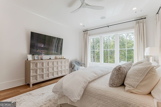 bedroom with hardwood / wood-style floors and ceiling fan