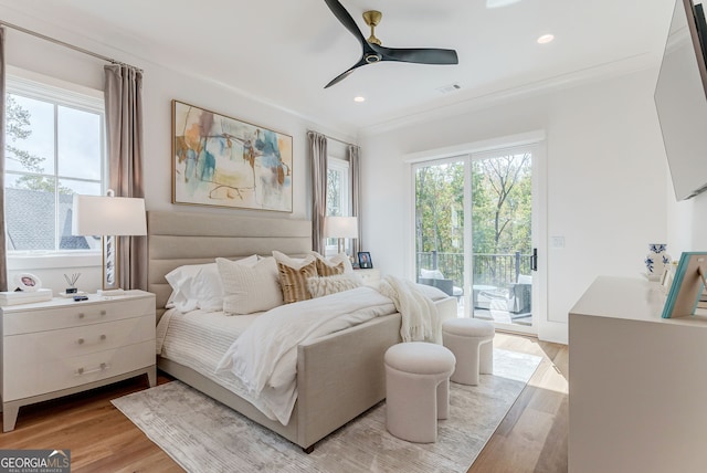 bedroom featuring ornamental molding, light wood-type flooring, ceiling fan, and access to exterior