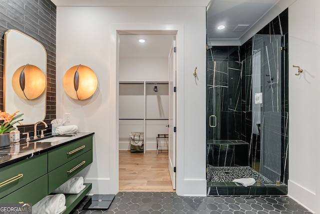 bathroom with vanity, hardwood / wood-style floors, and a shower with door