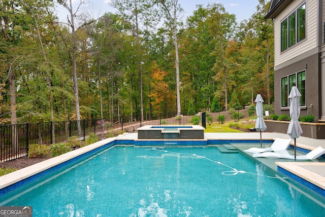 view of swimming pool with an in ground hot tub