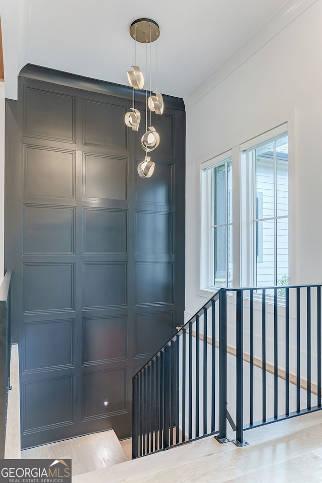 staircase featuring ornamental molding