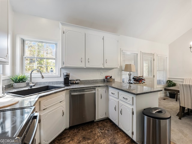 kitchen with white cabinets, sink, lofted ceiling, and stainless steel appliances