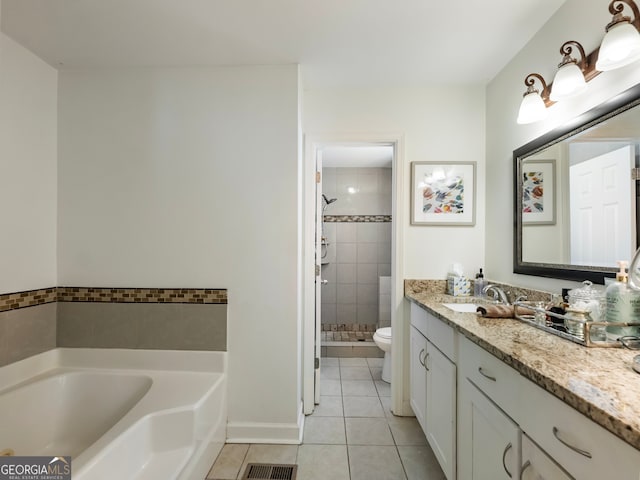 full bathroom with tile patterned flooring, shower with separate bathtub, vanity, and toilet