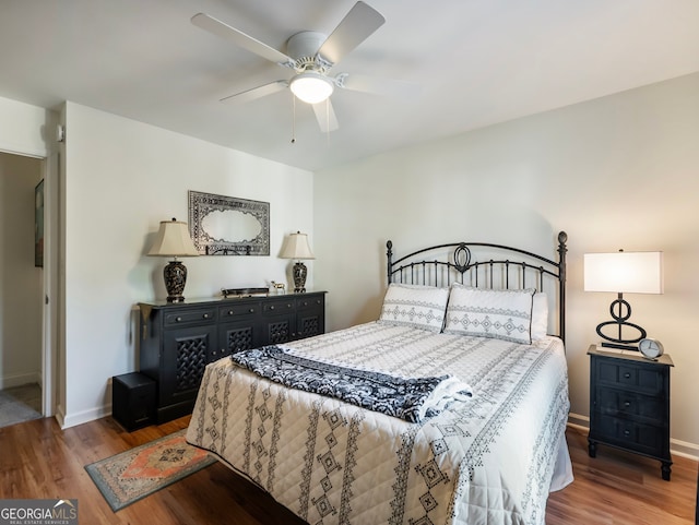 bedroom with ceiling fan and wood-type flooring