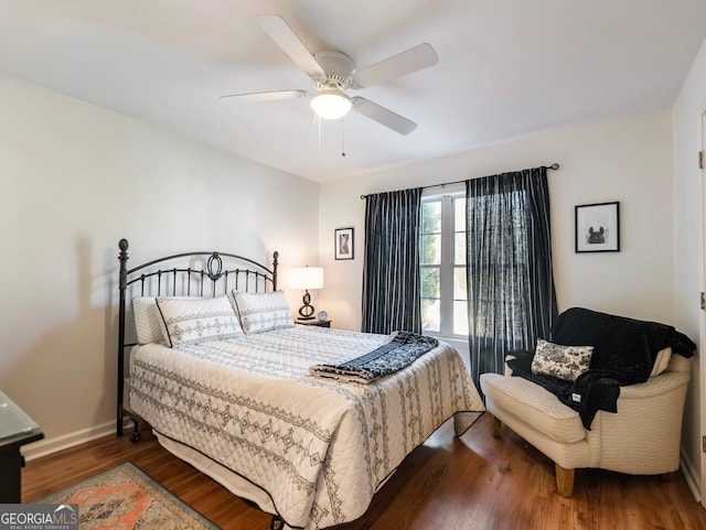 bedroom featuring ceiling fan and dark hardwood / wood-style flooring