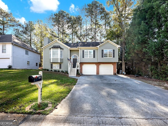 bi-level home with a front yard and a garage