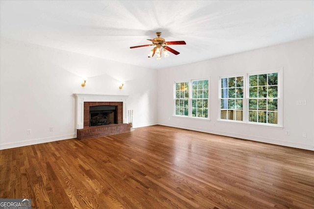 unfurnished living room with ceiling fan, a fireplace, and hardwood / wood-style flooring