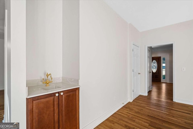 corridor featuring dark hardwood / wood-style flooring and sink