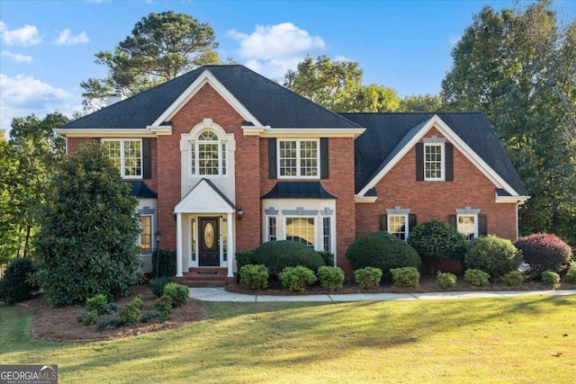 colonial inspired home with a front lawn