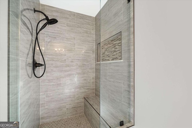 bathroom with tiled shower