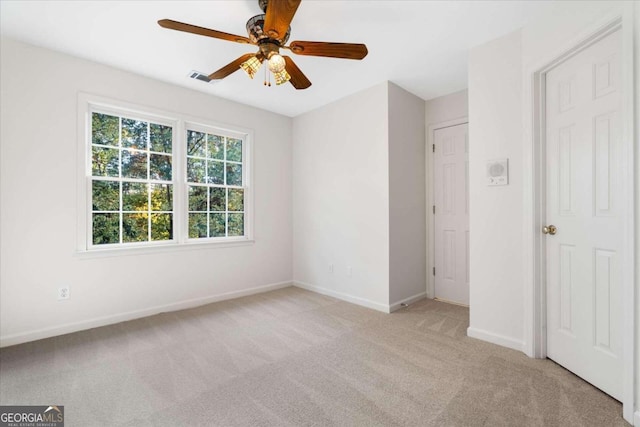 unfurnished bedroom with ceiling fan and light colored carpet