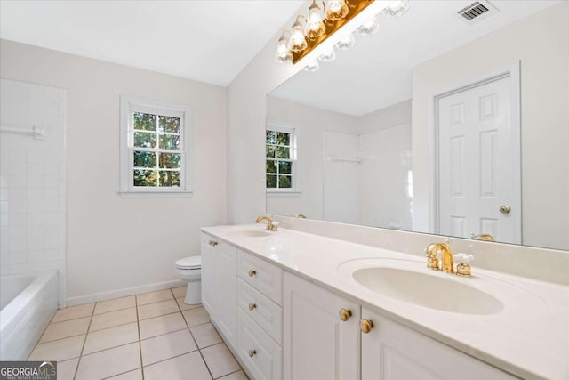 bathroom with toilet, vanity, and tile patterned floors