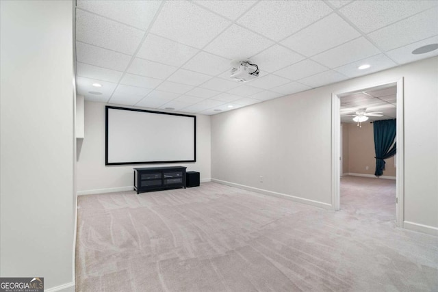 home theater featuring light carpet, a paneled ceiling, and ceiling fan