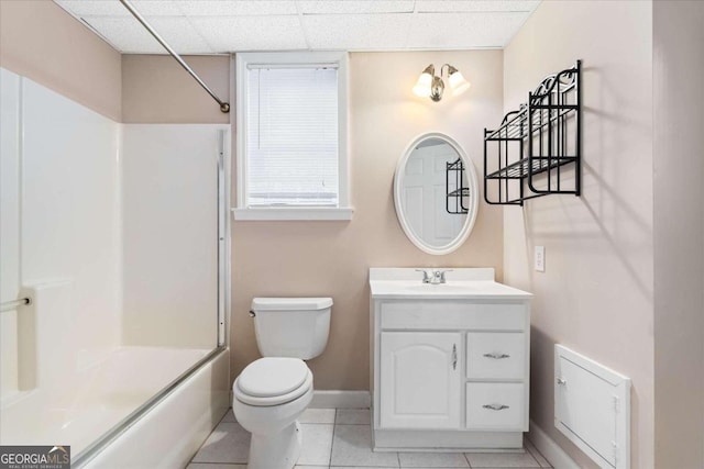 full bathroom with tile patterned floors, a drop ceiling, vanity, shower / bathing tub combination, and toilet