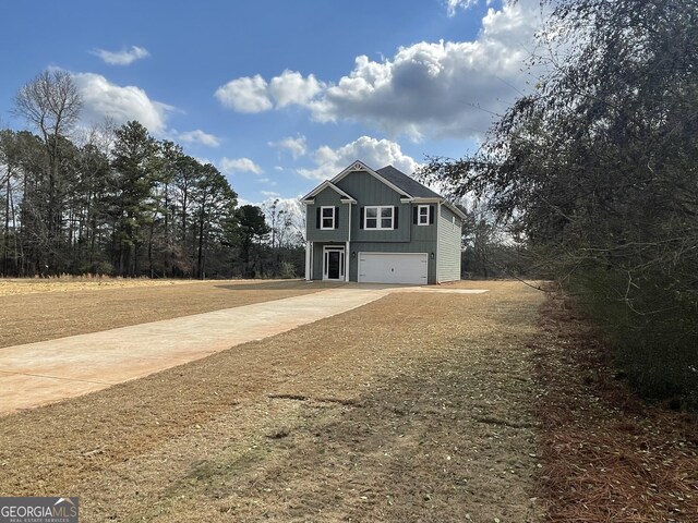 view of side of home featuring a garage and a yard