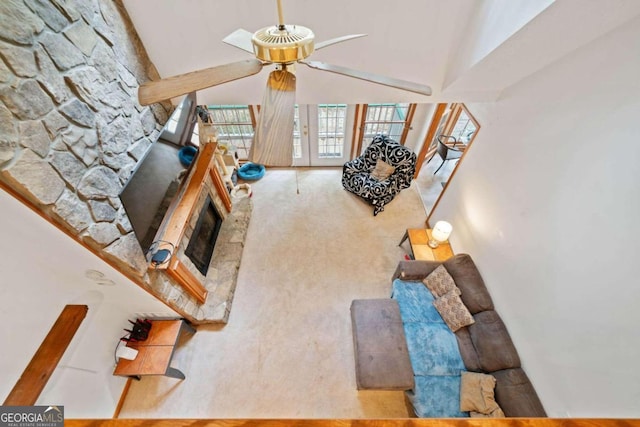 carpeted living room featuring ceiling fan and high vaulted ceiling